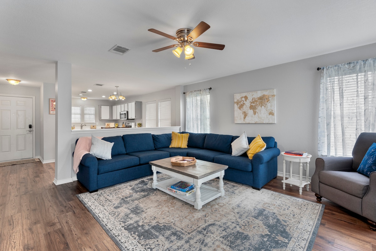 Living room with blue sofa near Cedar Park